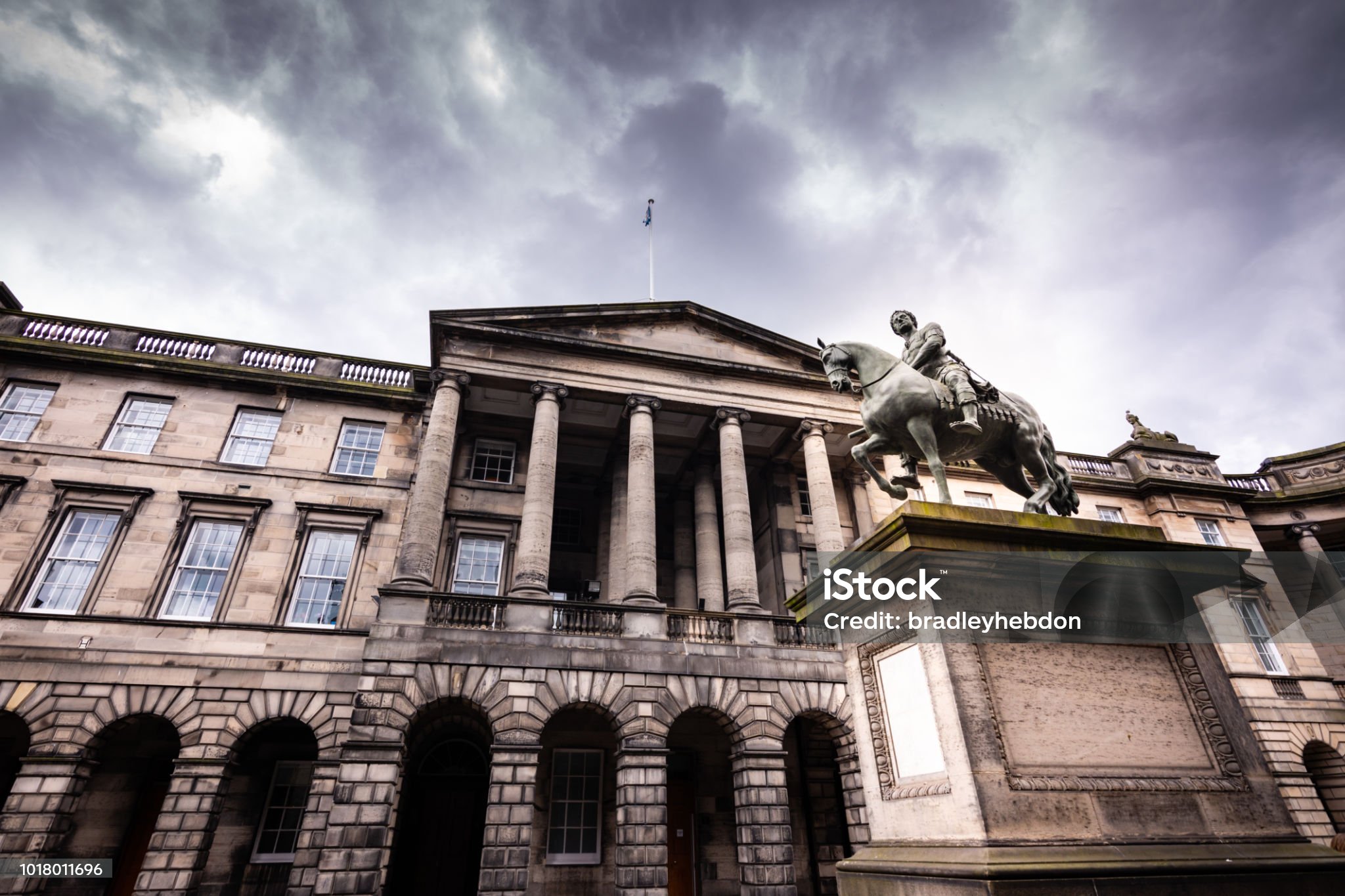 Cityscape of Edinburgh with castle and rooftops at sunset